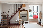 Low ceiling, full-length mirror and staircase in dining room