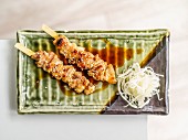 Grilled skewers with sesame seeds and radish salad (Japan)