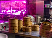 Stacks of bamboo steamers in a restaurant kitchen