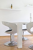 Glossy shell chairs and chunky table in white modern dining room