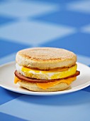 An English muffin with Canadian bacon and Cheddar cheese