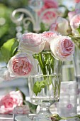 Pink roses in drinking glass