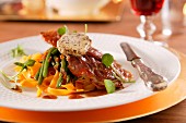 Veal escalope with crispy raw ham and herb mozzarella on green beans and tagliatelle