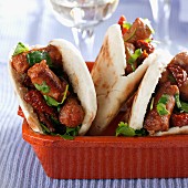 Pita bread with spicy sausages and coriander