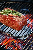 Indirect grilling of meat over an area of the barbecue with no coals