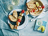 Grilled fish skewers with cherry tomatoes and baguette