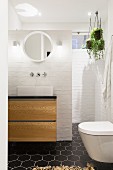 Bathroom with white brick walls and black hexagonal floor tiles