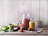 Red, yellow and green smoothies made with fruits and vegetables