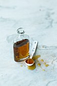 Maple syrup in a bottle and on a spoon