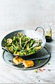 Stir-fried green asparagus with crispy feta cheese, limes and mint