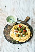 Curry falafel with corn tortillas with green sauce and sesame seeds