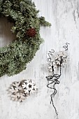 Wreath next to wooden snowflakes