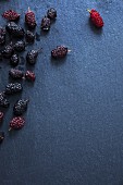 Fresh mulberries on a slate surface