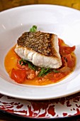 Seared seabass with tomatoes and sage