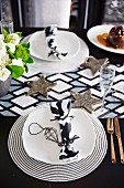 Black and white place setting on a Christmas table