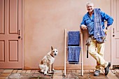 Dog and artisan next to self-made ladder