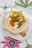 Steamed vegetables with yoghurt and a mint sauce in a pasty dish
