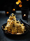 Burfi (Indian vanilla sweets) with golden blueberries
