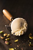 A scoop of pistachio nut ice cream in an ice cream server