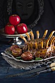 A crown of pork ribs with raisin-filled apples for Halloween