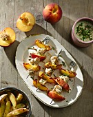Chicken and peach skewers with a sesame seed and herb sauce