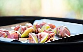 Fig skewers with Serrano ham on a barbecue