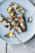 Razor clams with radish and edible flowers