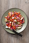 Red vegetable salad with tomatoes, apples, radishes and peppers