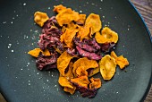 Colourful vegetable crisps (carrots, parsnips and beetroot) with salt