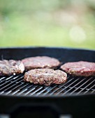 Lean beef burgers on a barbecue