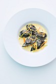 Black mussel ravioli in a saffron and curry sauce