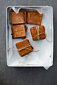 Cinnamon waffles stacked in a biscuit tin