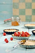 Raspberry tartlets with slivered almonds and jam