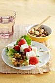 Goat's cheese and strawberry skewers on a lettuce leaf