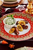 Beef wrapped in bacon with a herb sauce and fried plantains