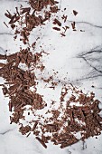 Grated dark chocolate on a marble surface