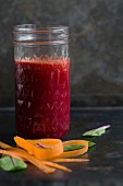 Beetroot juice with carrots in a jar