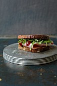 A ham sandwich with rocket and barbecue sauce