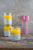 Three glasses of chia and coconut pudding with mango mousse