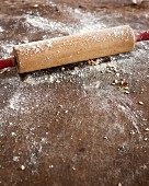 A wooden rolling pin dusted with flour