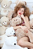 A young woman covered in teddy bears