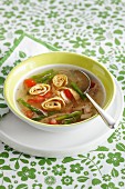Broth with asparagus and pancake rolls