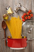 Ingredients and cooking utensils for a pasta dish (seen from above)