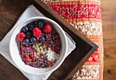 Homemade organic berry yoghurt with fresh fruit, coconut, and gogi berries