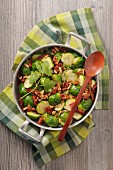 Fried brussels sprouts with dried tomatoes and pine nuts