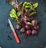 Beetroot with leaves and a knife