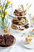 An Easter buffet with cake, biscuits and sandwiches