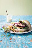 Grilled steak burger with chargrilled pears and a wholegrain mustard and blue-cheese sauce