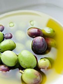 A bowl of olives and olive oil