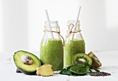 Green smoothies with avocado, kiwi, spinach, ginger and chia seeds